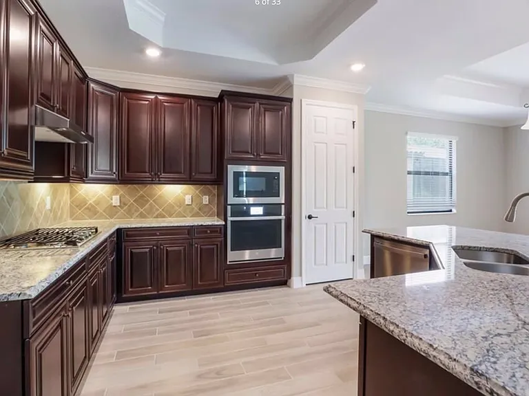 Stainless appliances, under cabinet lighting, granite and cherry wood throughout