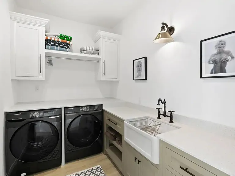 Laundry space with state of the art washer and dryer and spacious folding/storage area.