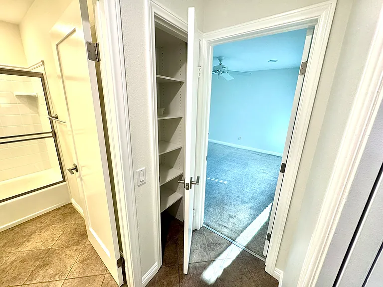 Secondary bedroom and entrance to secondary bathroom.