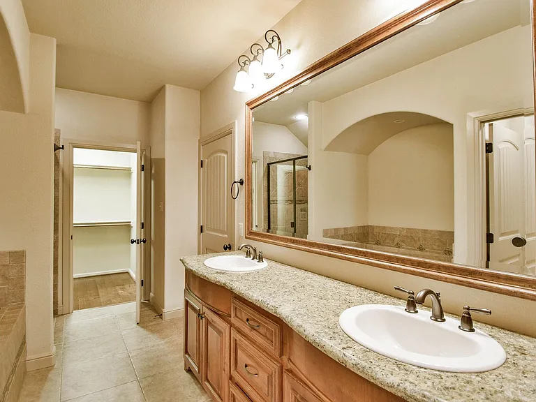 Primary bathroom with dual sinks and two closets