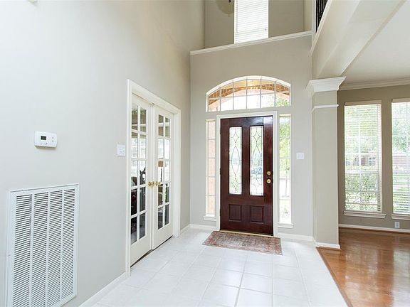 Bright and airy entry with leaded glass door.