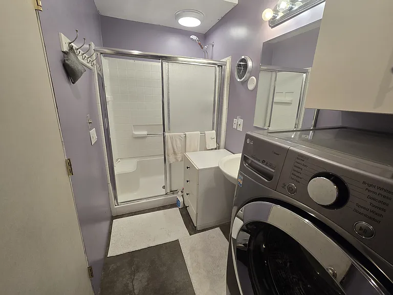 Drawers available next to shower. Clothes hooks near the shower. "Shower Envy" sprayer purifies water and creates a wonderful adjustable showering experience.