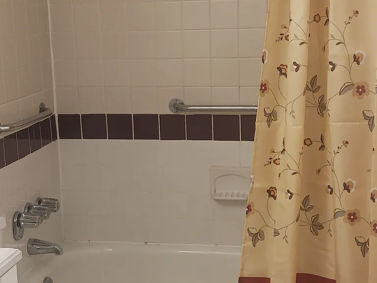Tub and shower in second bathroom.