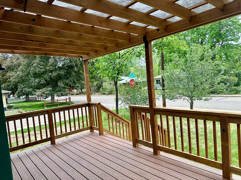 Shade cloth covered front porch faces east