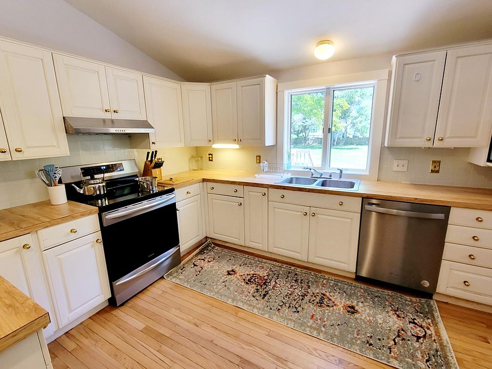 Updated kitchen with brand new stainless steel induction stove, dishwasher, and fridge/freezer