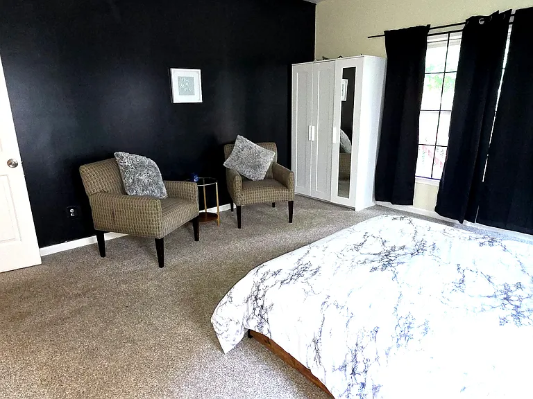 Fully furnished bed room with bed, mattress, walk in closet, extra cupboard, arm chairs, lamp, curtains, computer table/chair and ensuite full bath