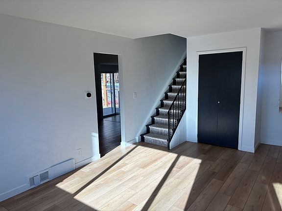 Front living room, stairs up to bedrooms, walk through to kitchen and family room