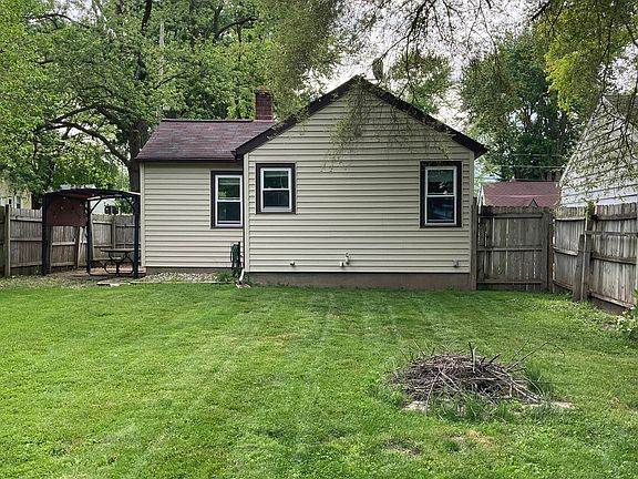 Back of the home with fenced in back yard.