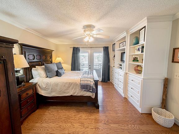 Master Bedroom located on main floor with patio access and built-ins.
