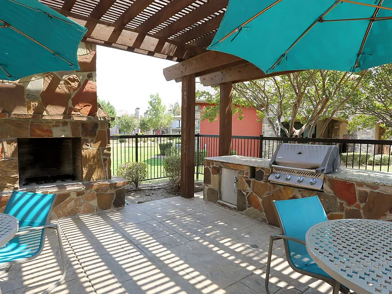 Inviting poolside retreat with shaded areas and outdoor relaxation space.