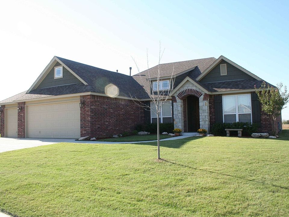 Front w/ arched rock entry and 3 car garage