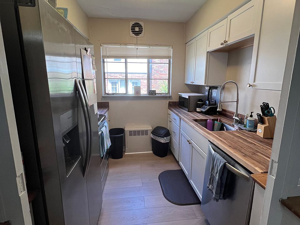 Newly updated kitchen featuring butcher block countertops and stainless appliances