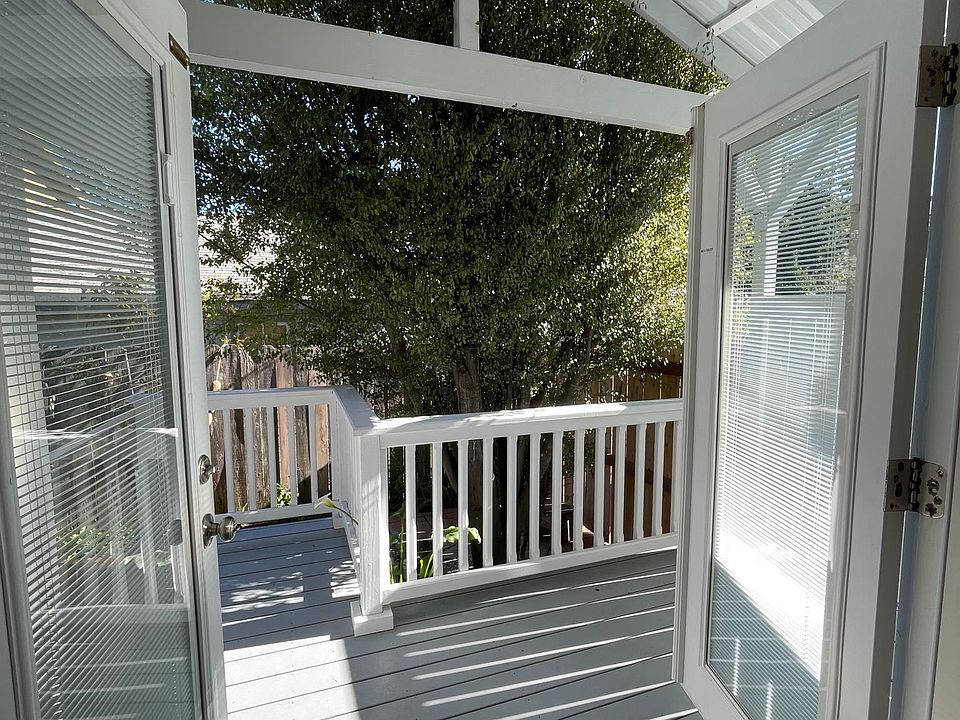 French doors open to own private covered deck, brick patio and garden.