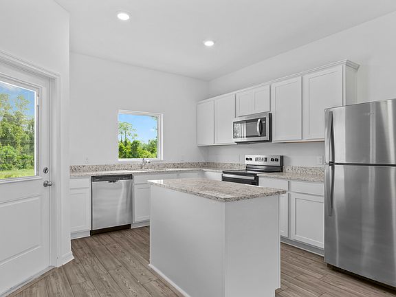 The kitchen is chef-ready with stainless steel appliances