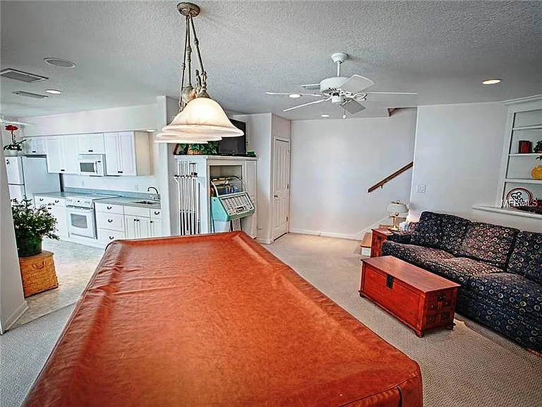 This is the downstairs apartment and has a full kitchen and bath with lots of storage. the pool table is not included. this BR/apartment can be separated from the upper two floors and it opens out on the lower screened patio off of the pool deck.
