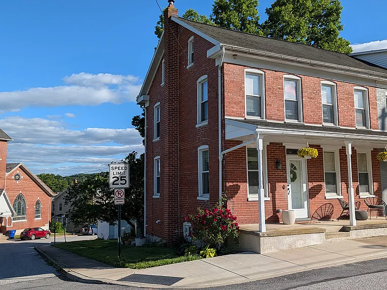 A corner lot on a quiet street. These townhouses have 15-inch thick brick firewalls between them from attic to rooftop, plus sound insulation between the studs.