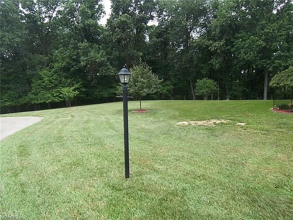 Here is the front yard and second large wooded lot.  Offers 1.3 acres.