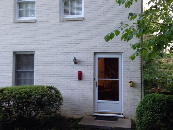 Brick duplex with landscaped front yard and driveway for 2 cars.