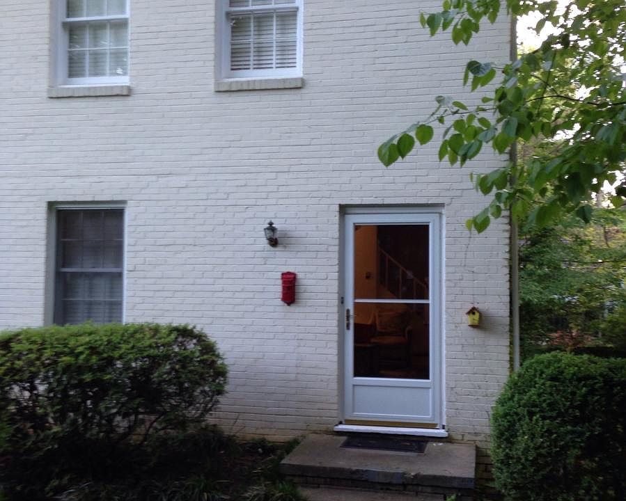 Brick duplex with landscaped front yard and driveway for 2 cars.