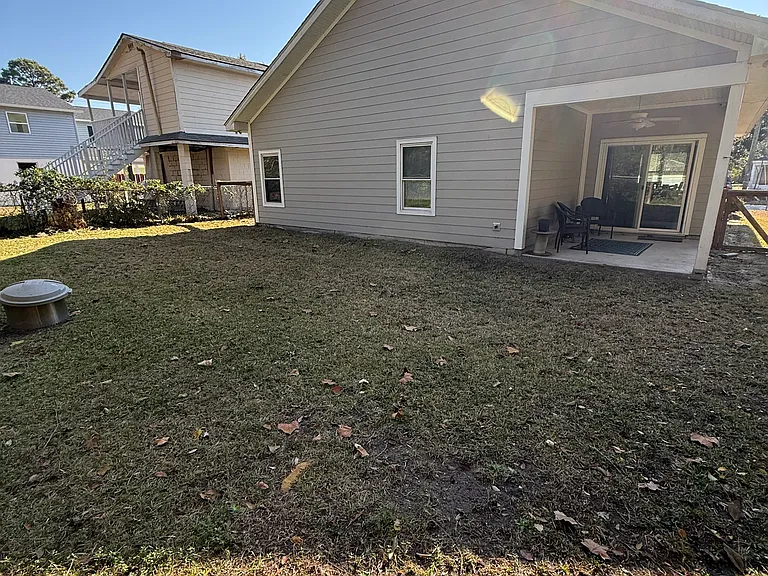fenced in yard & patio, with small fire pit