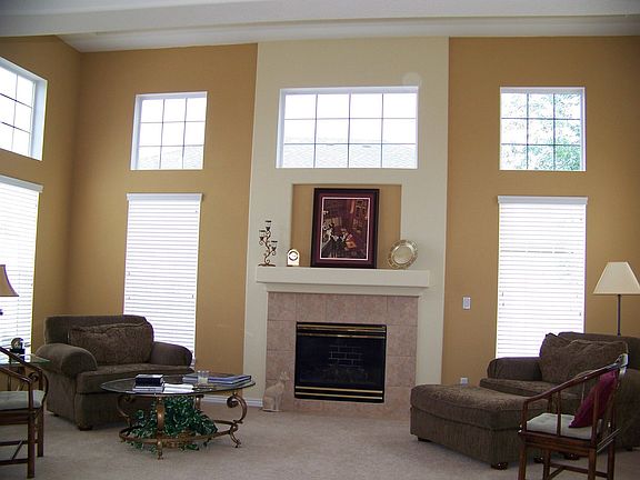 bright step-up living room with fire place
