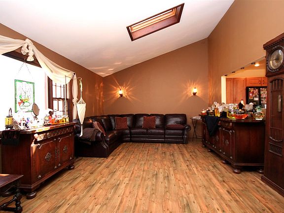 Living Room with Vaulted Ceilings & Skylight