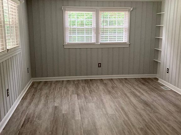 First room off carport. Lots of light. 
2" miniblinds. New flooring.