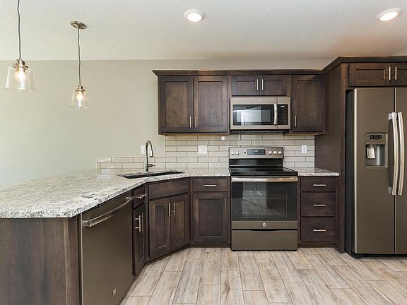 Eat in kitchen with granite counter tops and pantry.