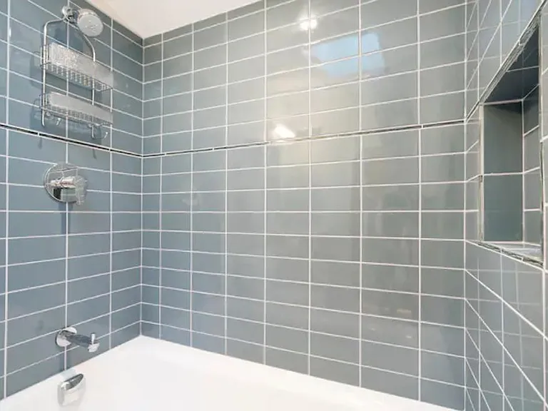 Lovely tiled shower. Not included: Shower caddy.