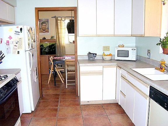 Kitchen features updated appliances and cabinets with dishwasher and gas stove