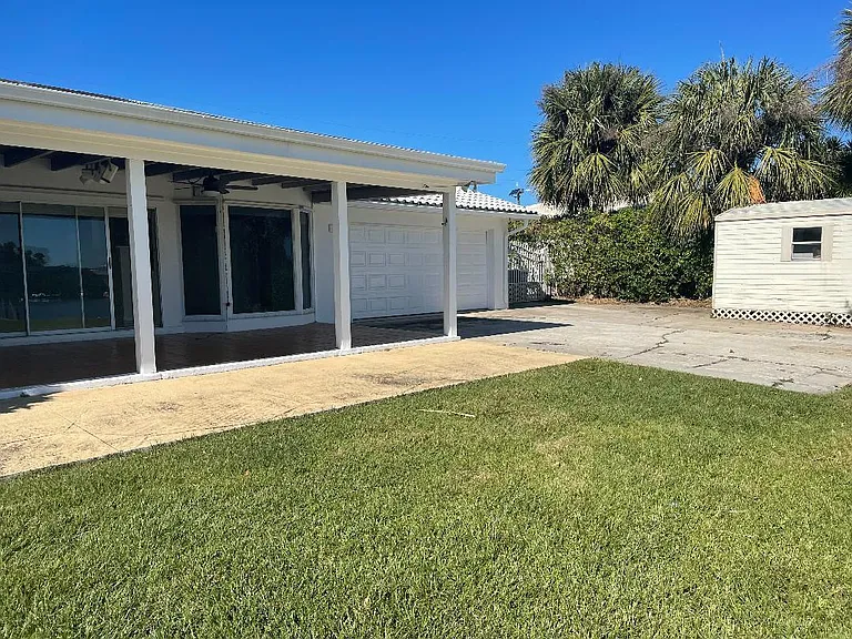 Back Covered Tiled Patio and Attached Concrete Patios