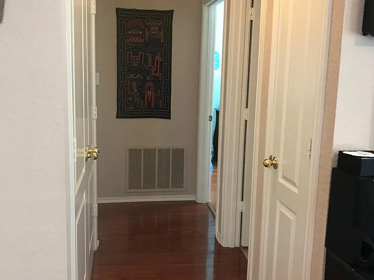 Corridor between living room and two downstairs bedrooms