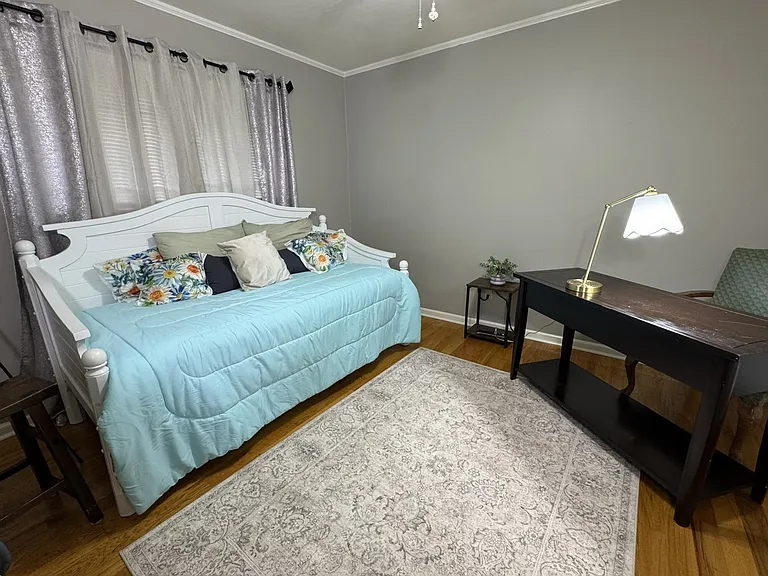 Third bedroom is a flex room with a daybed, a chest of drawers, and a desk