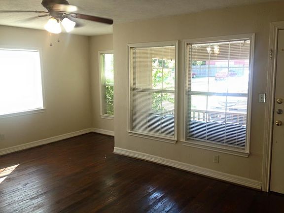 Living Room to the right with large windows, small dining area to the left of photo