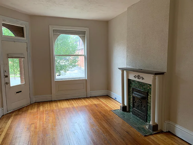 Front room with original fireplace (non-functional). Potential office space. Final painting in progress.