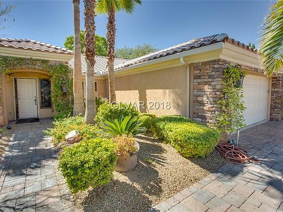 WOW!  CURB APPEAL !!!!   Exterior Front boasts brick paver driveway and walkway, lush landscaping with several palms trees.  Hom