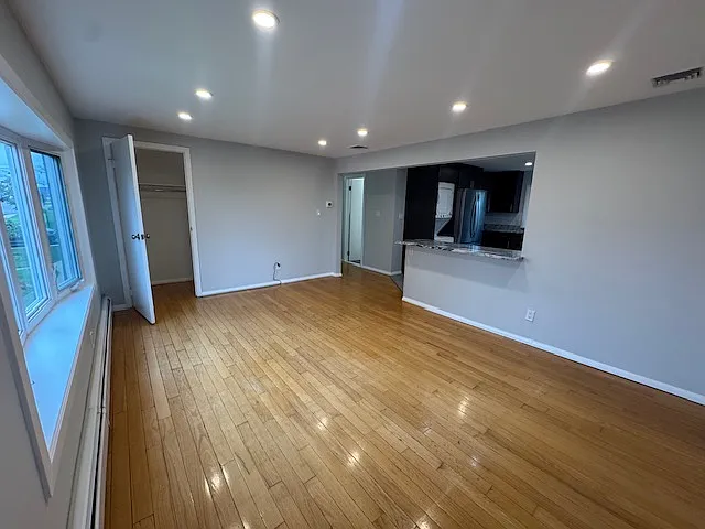Living room: image shows closet in space and opening to kitchen