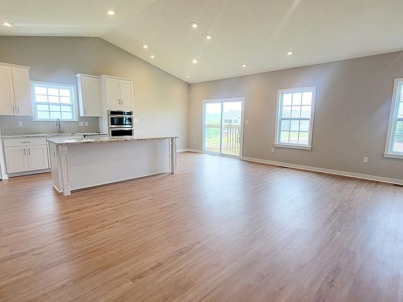 open concept family room kitchen with cathedral ceiling
