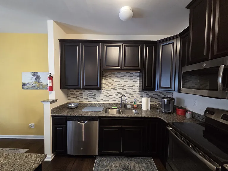 Kitchen sink, cabinets, and countertops