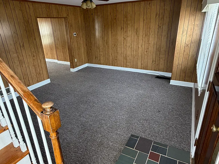View of living room from stair landing to 2nd floor.