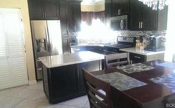 Kitchen with view of dining area, and washer and dryer closet.