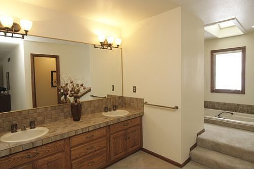 Elegant tile, updated light fixtures, and offers double sinks & a soaking tub.