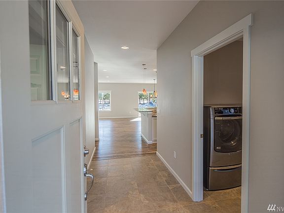 Ceramic tile in the entry and utility room (on the right) transitions to luxury handscraped wood-grain laminate throughout most of the main home for the perfect mix of beautiful and functional.