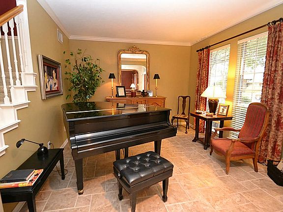 Living room accented by tile floors and crown molding.