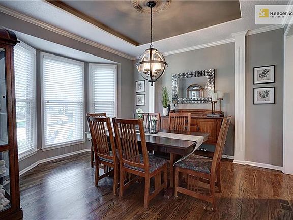 Classic formal dining room with bay window and new light fixture.