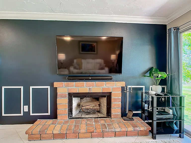 65" Wall mounted smart tv with premium cable. Fireplace is for display only (non-operational).