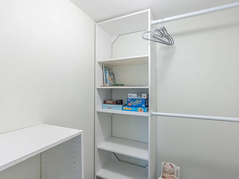 Guest bedroom walk in closet with new shelving