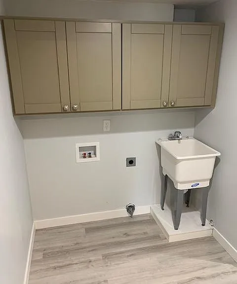 Lower level washer/dryer hookup with upgraded utility sink and cabinets
