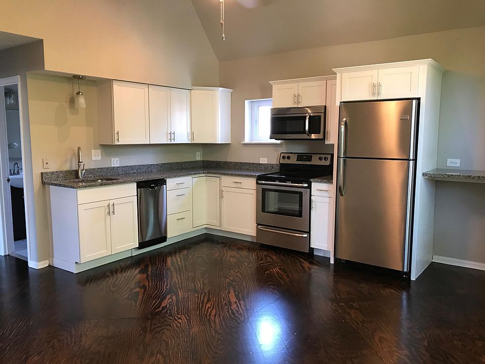 new kitchen with granite counters and stainless steel appliances