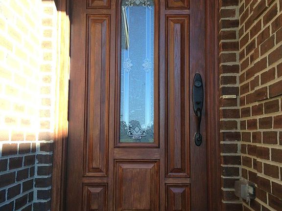 Impressive front door to foyer/living/dining/kitchen with hickory wood flooring